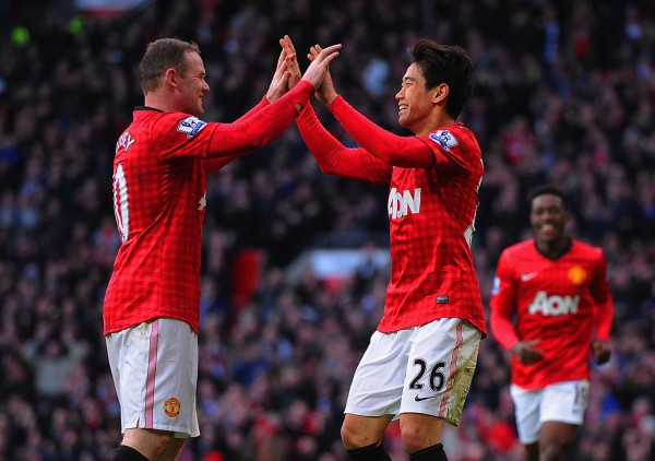 MANCHESTER, ENGLAND - MARCH 02:  Shinji Kagawa of Manchester United celebrates scoring to make it 2-0 with team mate Wayne Rooney during the Barclays Premier League match between Manchester United and Norwich City at Old Trafford on March 2, 2013 in Manchester, England.  (Photo by Michael Regan/Getty Images)