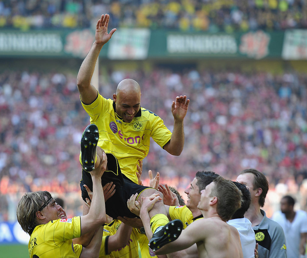 DORTMUND, GERMANY - APRIL 30: Dede of Dortmund is tossed in the air by players after winning the league title at the end of the Bundesliga match between Borussia Dortmund and 1. FC Nuernberg at Signal Iduna Park on April 30, 2011 in Dortmund, Germany. (Photo by Stuart Franklin/Bongarts/Getty Images)